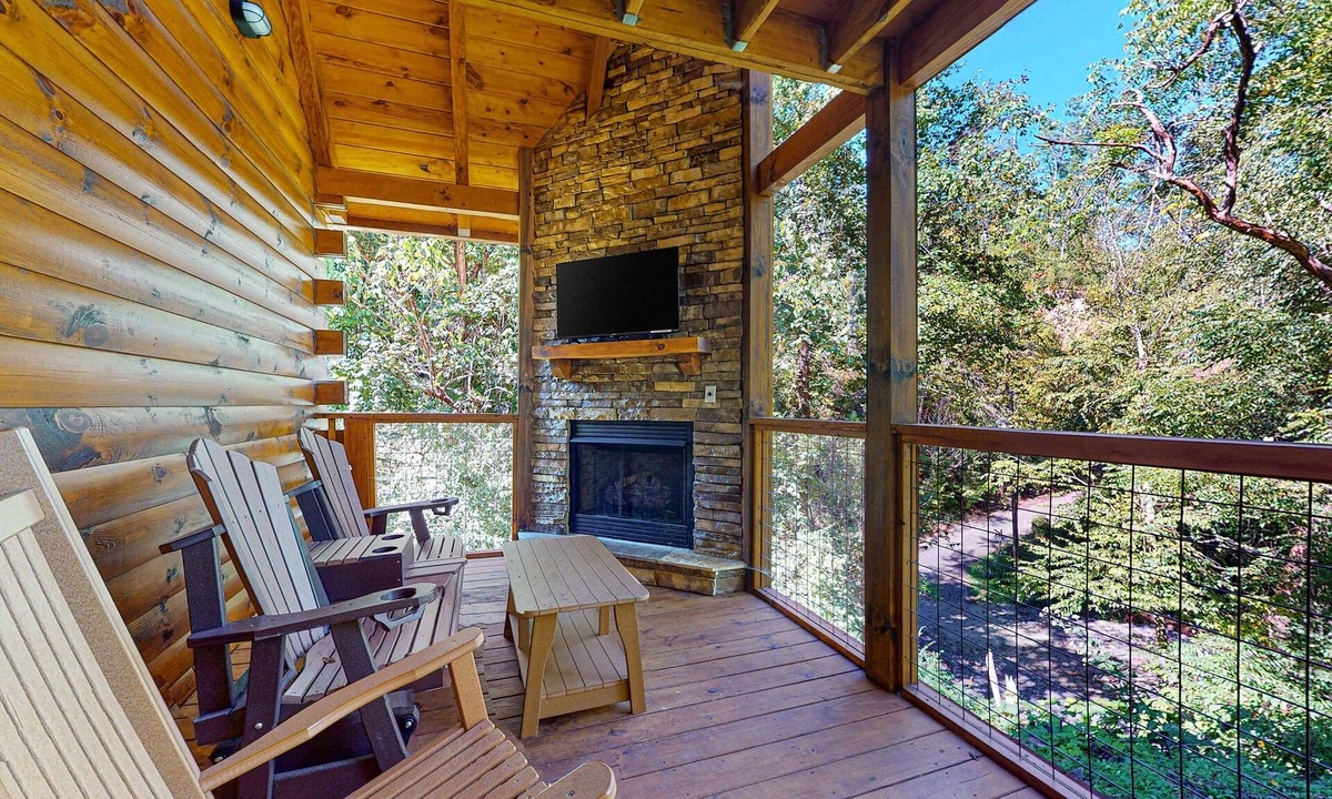 Chalet Village North Cabin | Wooded cabin w/hot tub, fireplaces, & furnished deck