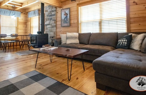 Roan Mountain Cabin | Experience the warm design and modern comfort of this gorgeous and private log cabin on Doe River