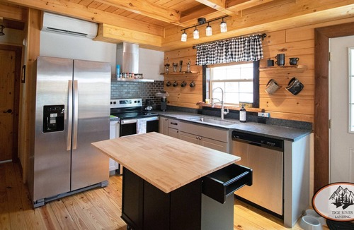 Roan Mountain Cabin | Experience the warm design and modern comfort of this gorgeous and private log cabin on Doe River