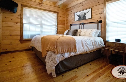 Roan Mountain Cabin | Experience the warm design and modern comfort of this gorgeous and private log cabin on Doe River