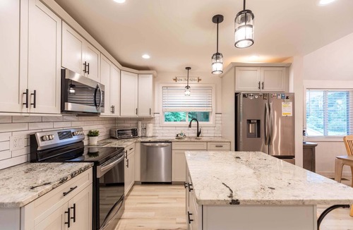 Newland House | Mill Timber Lodge: Creekfront home, dog friendly, firepit, yard, deck, WiFi & grill!