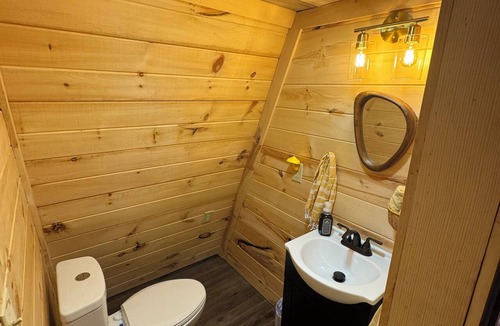 Corbin Cabin | The Naturalists is a peaceful off grid A frame cabin with an outdoor shower.