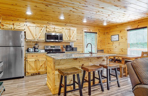 Chalet Village North Cabin | Wooded cabin w/hot tub, fireplaces, & furnished deck