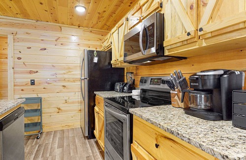 Chalet Village North Cabin | Wooded cabin w/hot tub, fireplaces, & furnished deck