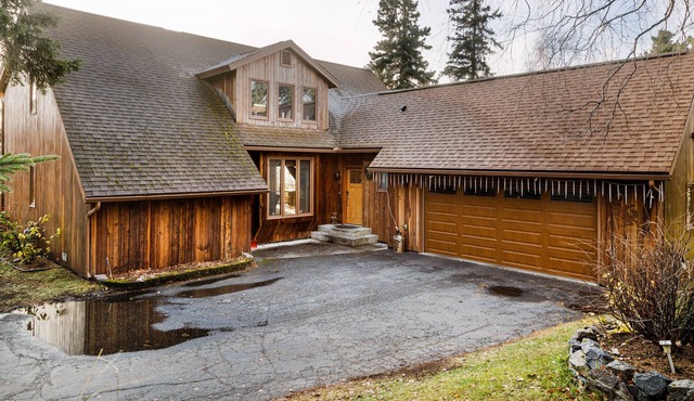 Secluded retreat with lush sunroom, scenic deck, fireplace & W/D